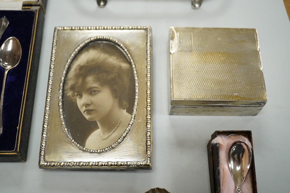Sundry small silver including a George V mounted photograph frame, James Deakin & Sons, Sheffield, 1918, 14.8cm, a mounted cigarette box, a teaspoon, two vesta cases and thimble, together with assorted plated ware.